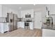 Modern kitchen featuring stainless steel appliances, sleek white cabinets, and gorgeous countertops at 3575 S Ouray St, Aurora, CO 80013