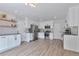 Bright open kitchen with modern appliances, white cabinets, and sleek countertops at 3575 S Ouray St, Aurora, CO 80013