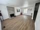 Open living room featuring a fireplace, new flooring, and a large window at 3575 S Ouray St, Aurora, CO 80013