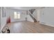 Bright living room featuring wood-look flooring, staircase, white trim, and lots of natural light at 3575 S Ouray St, Aurora, CO 80013