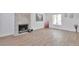 Bright living room featuring wood-look flooring, decorative fireplace, and lots of natural light at 3575 S Ouray St, Aurora, CO 80013