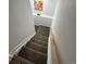 Staircase with carpeted steps, white risers, and a light wood handrail, leading to the basement at 3575 S Ouray St, Aurora, CO 80013