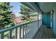 Scenic view from the wooden balcony showcases mature trees and lush greenery at 2437 E Geddes Pl, Centennial, CO 80122