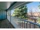 View from a wooden balcony showcases lush greenery, trees, and serene landscape at 2437 E Geddes Pl, Centennial, CO 80122