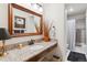Bathroom featuring granite counters, a wood vanity, and a shower with a tile surround at 2437 E Geddes Pl, Centennial, CO 80122