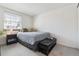 Cozy bedroom with a comfortable bed, bench seat, and a window offering natural light at 2437 E Geddes Pl, Centennial, CO 80122