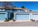 Blue townhomes featuring well-maintained garages and landscaping at 2437 E Geddes Pl, Centennial, CO 80122