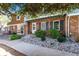 Charming brick townhome with delightful upstairs balcony and lovely rock and shrub landscaping at 2437 E Geddes Pl, Centennial, CO 80122
