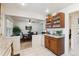 Kitchen showcases granite countertops, wood cabinetry, and an eat-in area with natural light at 2437 E Geddes Pl, Centennial, CO 80122