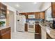 Bright kitchen boasts granite counters, white appliances, tile flooring, and plentiful cabinet storage at 2437 E Geddes Pl, Centennial, CO 80122