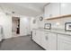 Practical laundry area features white cabinets, counter space, and easy access to the adjacent room at 2437 E Geddes Pl, Centennial, CO 80122