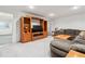 Relaxing living room features comfortable seating, a wooden entertainment center, and soft lighting at 2437 E Geddes Pl, Centennial, CO 80122