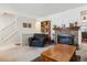 Inviting living room showcases a brick fireplace, cozy seating, and ample natural light at 2437 E Geddes Pl, Centennial, CO 80122