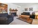 Comfortable living room features a cozy brick fireplace, plush seating, and stylish decor at 2437 E Geddes Pl, Centennial, CO 80122