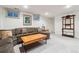 Comfortable living room boasts a large sectional, wooden coffee table, and natural light at 2437 E Geddes Pl, Centennial, CO 80122