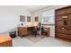 Bright office featuring a wood desk, bookcase, and a window offering natural light at 2437 E Geddes Pl, Centennial, CO 80122