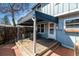 Relaxing covered patio with wood deck, table and chairs, and access to the house at 2437 E Geddes Pl, Centennial, CO 80122