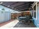 Charming covered patio with wood deck, table and chairs, and fence access at 2437 E Geddes Pl, Centennial, CO 80122