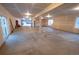 Large unfinished basement with smooth concrete flooring and bright lighting fixtures at 5462 S Cedar St, Littleton, CO 80120