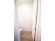 Powder room featuring white walls, wood-look flooring, and a toilet with a modern white design at 5462 S Cedar St, Littleton, CO 80120