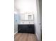 Modern bathroom featuring double sink vanity, quartz counters, and glass shower at 5462 S Cedar St, Littleton, CO 80120