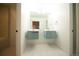 Bright bathroom featuring a double sink vanity, modern fixtures, and hexagon tile flooring at 5462 S Cedar St, Littleton, CO 80120