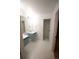 Well-lit bathroom with a modern vanity, sleek fixtures, and contemporary hexagon tile flooring at 5462 S Cedar St, Littleton, CO 80120