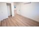 Bright bedroom with wood-look flooring, closet, and an open doorway at 5462 S Cedar St, Littleton, CO 80120