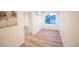Bedroom with wood-look flooring, white walls, interior door, and a view of the outside at 5462 S Cedar St, Littleton, CO 80120