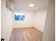 Cozy bedroom featuring hardwood floors, neutral paint, and air conditioning unit at 5462 S Cedar St, Littleton, CO 80120