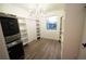Well-organized walk-in closet with built-in shelves, chandelier lighting, and a laundry center at 5462 S Cedar St, Littleton, CO 80120