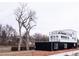 Contemporary two-story home boasting sleek black and white exterior, and multiple balconies for outdoor enjoyment at 5462 S Cedar St, Littleton, CO 80120