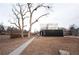 View of the back of a modern home with black siding and a white upper level, and multiple balconies at 5462 S Cedar St, Littleton, CO 80120