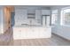 Bright, modern kitchen featuring white cabinets, stainless appliances, and a large center island at 5462 S Cedar St, Littleton, CO 80120