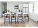 Bright kitchen features a large island, modern white cabinets, and sleek black bar stools at 5462 S Cedar St, Littleton, CO 80120