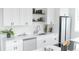 Modern kitchen featuring quartz countertops, stainless steel appliances, and open shelving at 5462 S Cedar St, Littleton, CO 80120