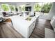 This gourmet kitchen features a large island and access to an outdoor deck with sliding glass doors at 5462 S Cedar St, Littleton, CO 80120