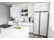 Modern kitchen with white cabinets, stainless steel appliances, and quartz countertops at 5462 S Cedar St, Littleton, CO 80120