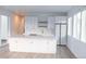 Bright kitchen with white cabinetry, large island, stainless appliances, and modern fixtures at 5462 S Cedar St, Littleton, CO 80120