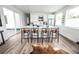 Bright kitchen features a large island, modern white cabinets, and sleek black bar stools at 5462 S Cedar St, Littleton, CO 80120