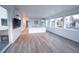 Open concept living room and kitchen with hardwood floors and abundant natural light at 5462 S Cedar St, Littleton, CO 80120