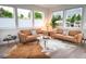 Bright, airy living room with large windows, neutral walls, modern flooring, and stylish furniture at 5462 S Cedar St, Littleton, CO 80120