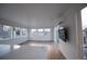 Bright open-concept living room with many windows and sliding glass door to the outdoors at 5462 S Cedar St, Littleton, CO 80120