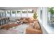 Bright living room featuring large windows, stylish sofas, hardwood floors, and modern decor at 5462 S Cedar St, Littleton, CO 80120