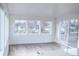 Bright living room with large windows, open floor plan, and sliding glass door at 5462 S Cedar St, Littleton, CO 80120