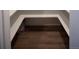 Walk-in closet with custom white shelving and wood floors. This closet has built-in storage solutions at 5462 S Cedar St, Littleton, CO 80120
