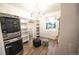 Custom walk-in closet features a washer and dryer and custom shelving at 5462 S Cedar St, Littleton, CO 80120