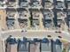 An aerial view of a neighborhood showcasing the layout and proximity of houses with solar panels on the roofs at 8409 Rush Creek Ave, Littleton, CO 80125