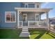 Charming covered back porch with seating, ideal for relaxing and enjoying the outdoors at 8409 Rush Creek Ave, Littleton, CO 80125
