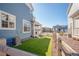 Fenced backyard with well-maintained artificial turf and surrounding houses at 8409 Rush Creek Ave, Littleton, CO 80125
